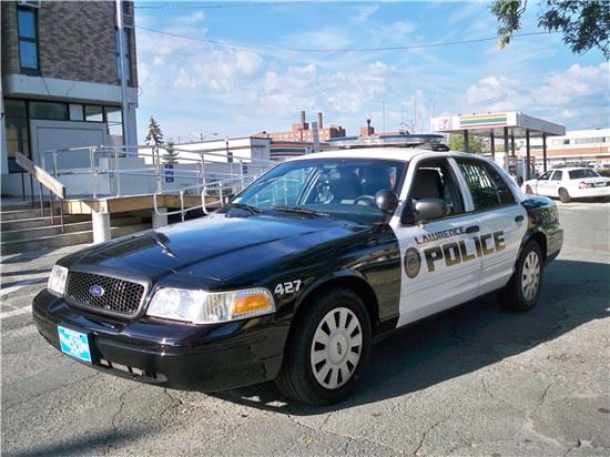 Black and white police cruiser in a parking spot